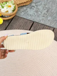 Detail view of the durable non-slip ribbed sole on women's flat beach sandals with size 37 mark.