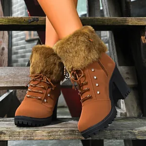 Close-up detail of brown high-heel ankle boots featuring a plush fur collar and rhinestones.