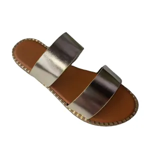 Elegant women's metallic gold double strap flat sandals with a comfortable tan footbed