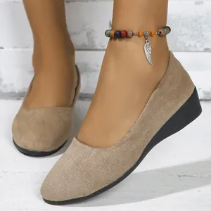 Detail view of khaki suede pointed-toe wedge flats for women with a beaded wing anklet.
