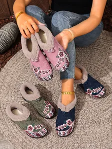 Detailed close-up view of ethnic floral embroidered warm slippers with plush fur lining