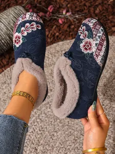 Detailed close-up of ethnic floral embroidered winter shoes with warm grey faux fur lining