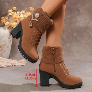Close-up detail of stylish brown rhinestone ankle boots with 8.5cm high heel measurement