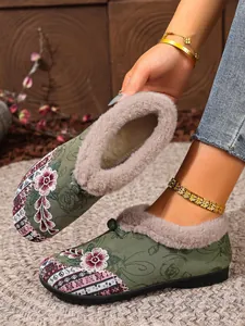 Detailed view of green embroidered winter snow boots featuring a thick warm plush lining