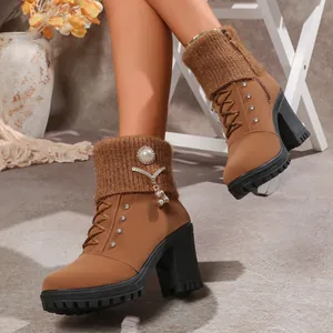 Side view of brown high-heeled boots with knitted cuffs and rhinestone pearl charms
