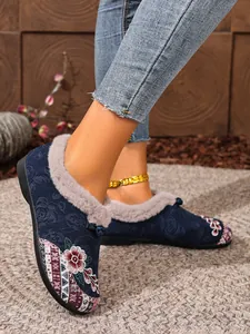 Detailed view of women's ethnic style embroidered fleece-lined slip-on flats in navy blue