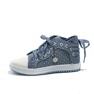 Detailed side view of trendy blue polka dot high-top sneakers featuring a white flower charm.