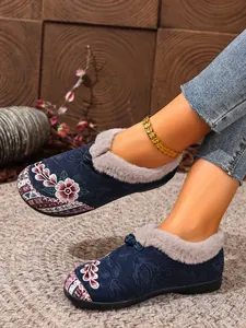 Detailed view of embroidered ethnic style cotton shoes with warm faux fur lining