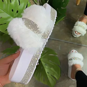 Detailed view of white faux fur platform slippers with luxury sparkling rhinestone accents
