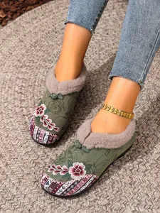 Detailed view of women's embroidered winter loafers with warm fur lining and ethnic patterns