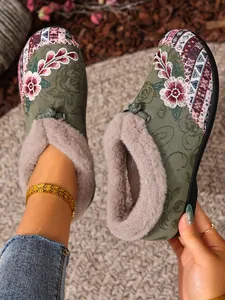 Detailed view of green winter cotton shoes with floral embroidery and warm plush fur lining.