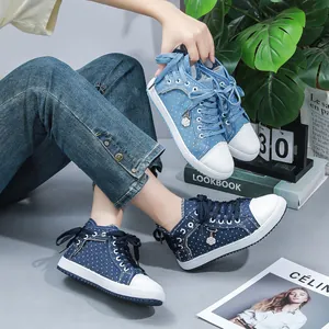 Side view of blue and navy polka dot high-top sneakers with denim fabric and lace-up.