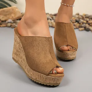Detailed view of stylish brown suede platform wedge sandals with a natural cork texture sole