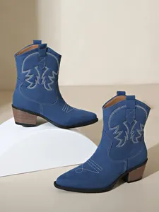 Blue suede western cowboy ankle boots featuring pointed toe and ornate white embroidery details