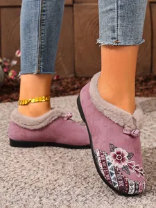 Close-up of ethnic embroidered women's flats with plush lining and floral pattern.