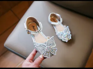 Detailed view of silver glitter girls' princess sandals with rhinestone butterfly bow