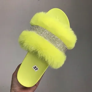 Neon yellow faux fur slide slippers for women featuring a sparkling rhinestone band.