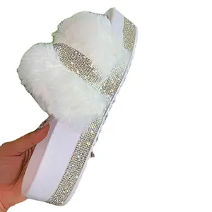 Women's platform slides featuring fuzzy faux fur and shimmering rhinestone accents