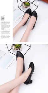 Professional detail view of classic black round-toe low-heel work pumps worn by a model