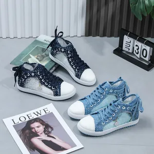 Detailed view of women's lace mesh high-top sneakers with polka dot denim finish
