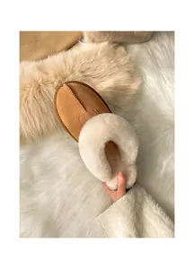Cozy women's faux fur lined slippers with tan suede exterior and soft plush collar.