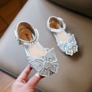 Detailed view of girls silver sparkle princess shoes with rhinestone butterfly and pearls.
