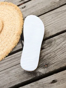 Macro view of the white anti-slip rippled sole texture on beach flip-flop sandals