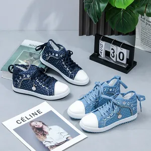 High-top polka dot canvas sneakers with side zipper and floral charm detail.