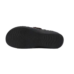 Detail view of anti-slip wavy pattern on the black sole of this casual women's flat sandal