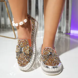 Close-up of sparkling rhinestone bow loafers for women with stylish thick soles