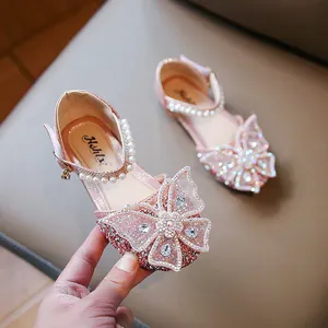 Sparkling pink girls' princess sandals with a large rhinestone butterfly bow and pearls