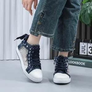 Detail view of stylish women's lace mesh high-top sneakers with navy polka dot pattern