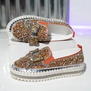 Detail view of sparkling rhinestone loafers with elegant bowknot and hand-stitched sole