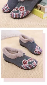 Close-up of elegant floral embroidery on warm winter snow boots with fur lining