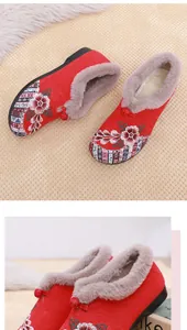 Detail view of traditional Chinese embroidered red winter boots with warm fur lining