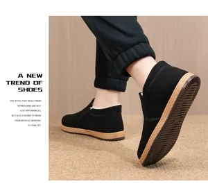 Detail view of warm fleece-lined black winter cotton shoes with non-slip tan soles