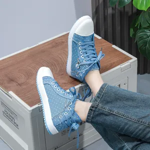 Blue polka dot high-top sneakers with side zipper and white laces for a casual look.