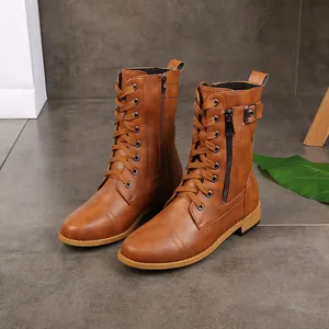 Close-up of brown lace-up women's Martin boots with side zipper and decorative buckle detail.