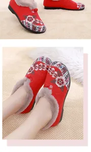 Detailed view of traditional Chinese embroidered shoes with warm fur lining on model