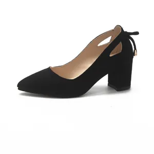 Side profile of black suede pointed-toe pumps with chunky heels and cutout detail