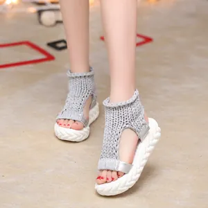 Vista dettagliata di eleganti sandali platform in maglia grigia da donna per l'estate