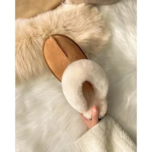 Detail view of women's brown winter slip-on shoe with thick white plush faux fur lining