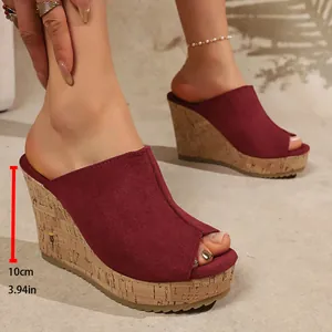 Close-up view of elegant burgundy peep-toe wedge sandals featuring a 10cm cork platform