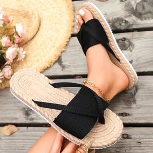 Stylish black cross strap beach slippers with a braided sole for summer vacation