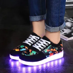 Detail of LED glowing sneakers with colorful graffiti pattern and USB charging port