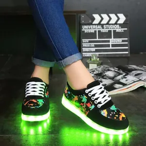Detailed view of stylish LED luminous sneakers featuring vibrant graffiti and green glowing soles