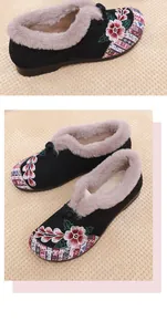 Detailed view of Chinese floral embroidery and soft faux fur lining on winter shoes