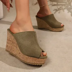 Close-up of olive green peep-toe wedge slide sandals featuring a cork-textured platform sole