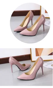 Close-up view of pink patent leather pointed-toe stiletto high heels with glossy finish.