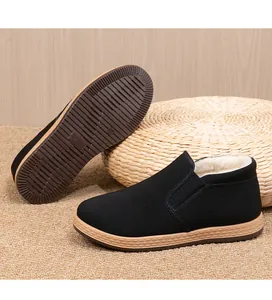 Detail view of fleece-lined winter cloth shoes showing non-slip sole and warm interior.